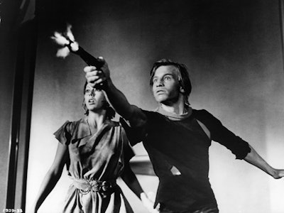 Jenny Agutter watches as Michael York fires a gun in a scene from the film 'Logan's Run', 1976. (Pho...