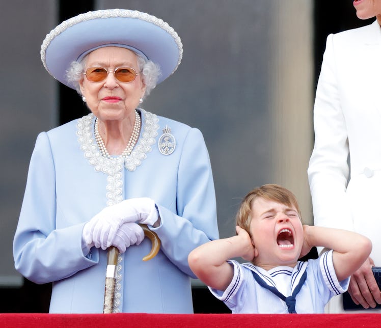  Queen Elizabeth II and Prince Louis of Cambridge watch a flypast from the balcony of Buckingham Pal...