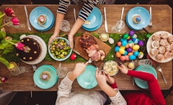 Overhead view on decorated Easter table with family around, in a story about leftover ham recipes.