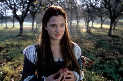 Drew Barrymore holding apple in a scene from the film 'Ever After: A Cinderella Story', 1998. (Photo...