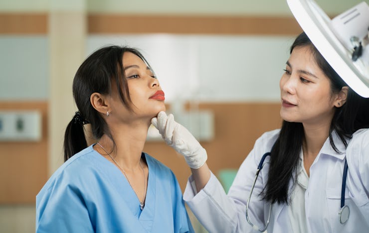 woman making an appointment with a doctor doing cosmetic medicine.Doctor taking care of woman and do...