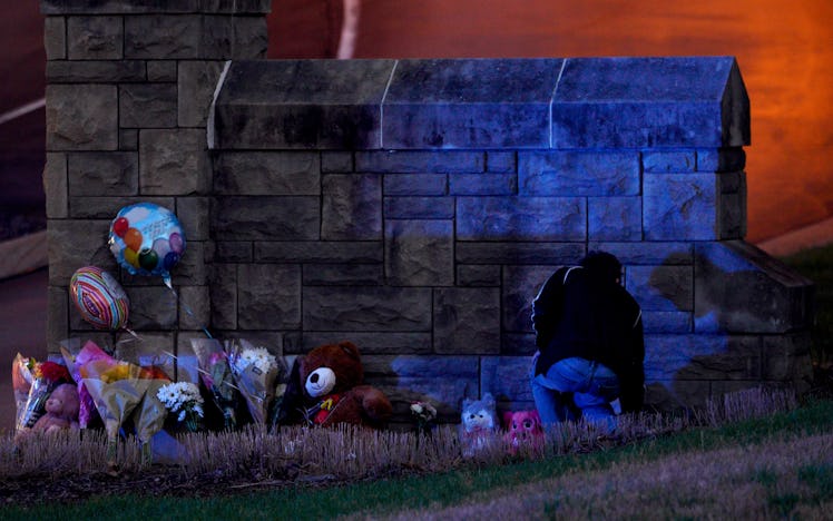 NASHVILLE, UNITED STATES - MARCH 27: A man places flowers at the entrance of the Covenant School, a ...