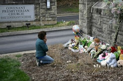 TOPSHOT - Robin Wolfenden prays at a makeshift memorial for victims outside the Covenant School buil...