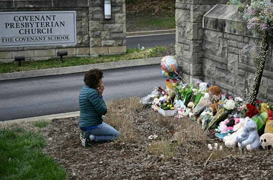 TOPSHOT - Robin Wolfenden prays at a makeshift memorial for victims outside the Covenant School buil...