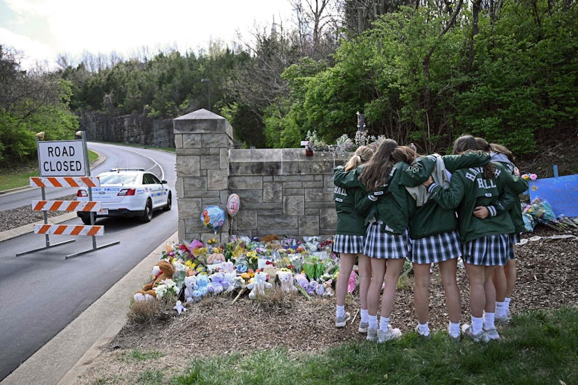 Girls embrace in front of a makeshift memorial for victims by the Covenant School, in a story about ...