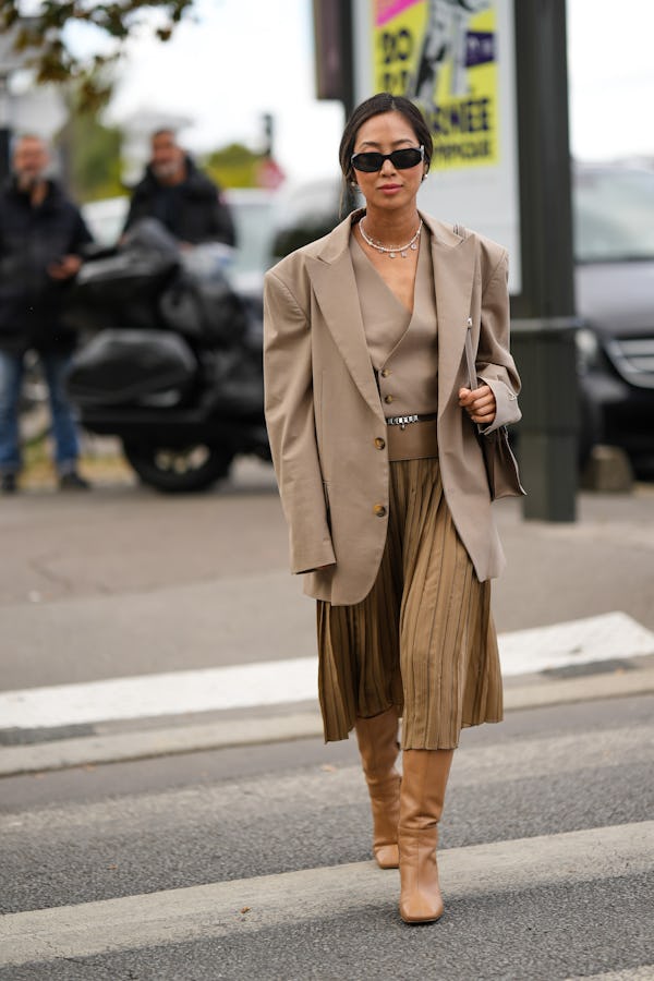 PARIS, FRANCE - OCTOBER 01: Aimee Song wears black sunglasses from Prada, gold chain pendants neckla…