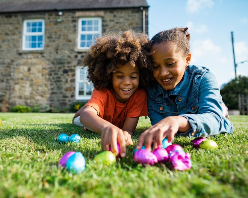 Two kids with easter eggs in a list of Easter bunny ideas for parents.