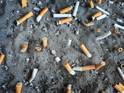 Cigarettes in public bin with ashtray