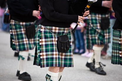 Bagpipers marching in a parade, the history of ST. patricks day colors