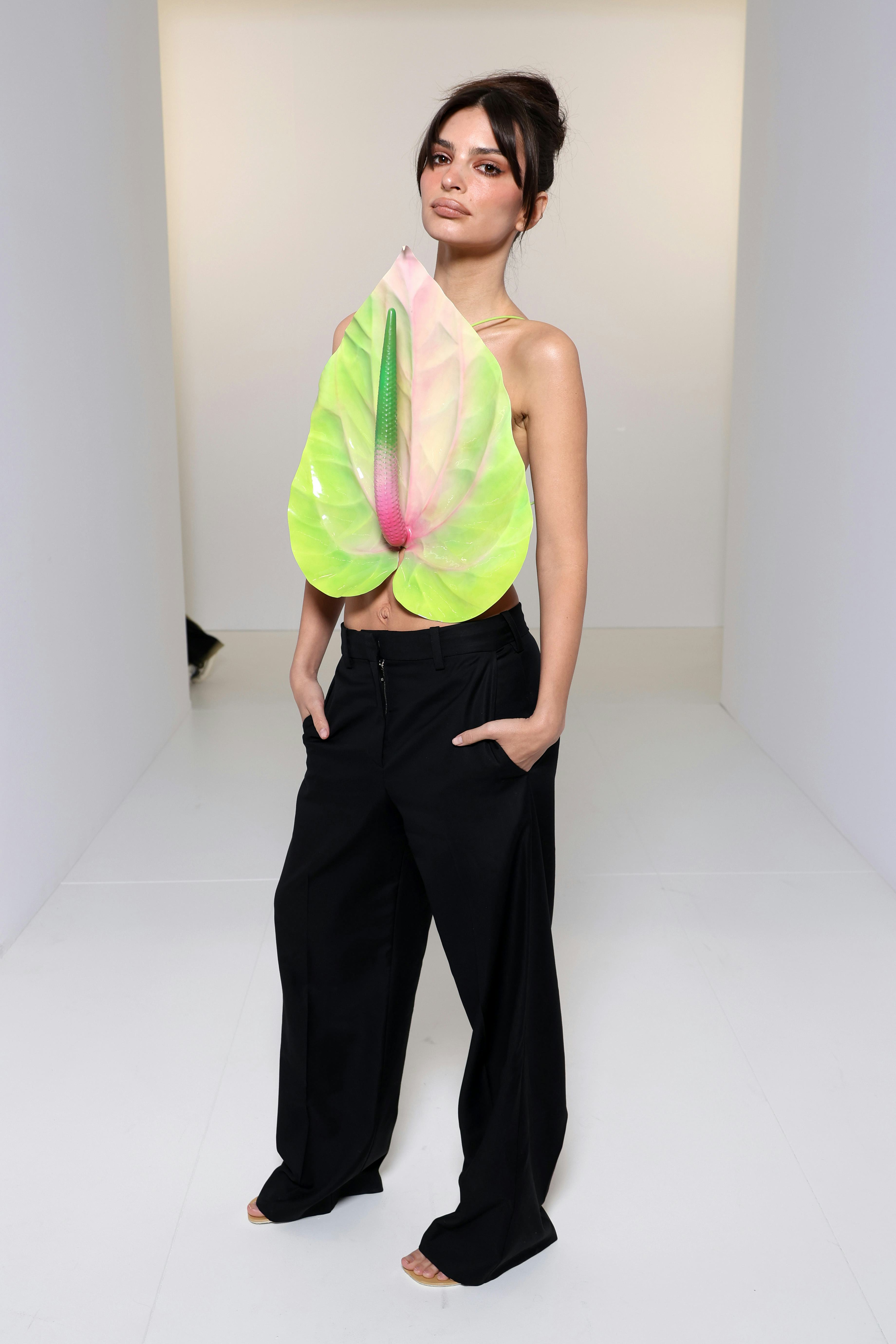 Emily Ratajkowski attended the Loewe show in an anthurium top.