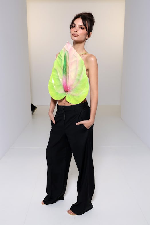 Emily Ratajkowski attended the Loewe show in an anthurium top.