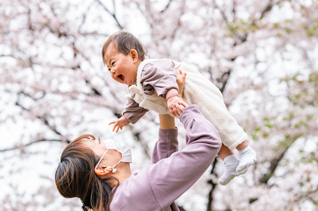photo of mother and baby daughter enjoying cherry blossoms in article about names for babies born in...