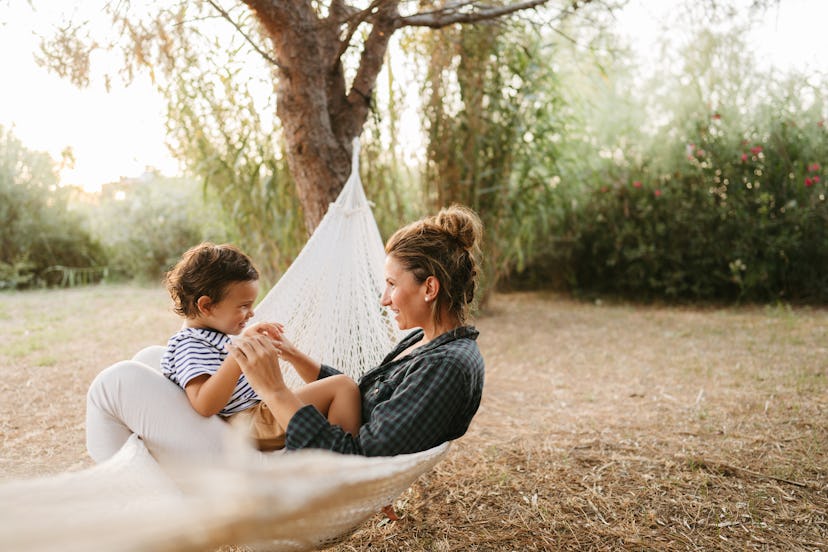 Photo of a little boy and his mother having a relaxing moment in a hammock, in an article about what...