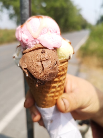 Strawberry Icecream, Vanilla, Coconut Milk, Chocolate in a waffle cone