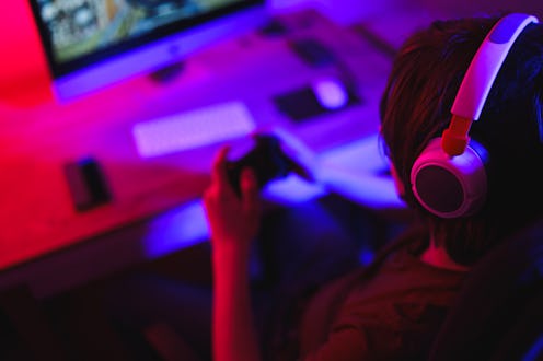 Teenage Boy Playing Multiplayer Games on Desktop Pc in his Dark Room