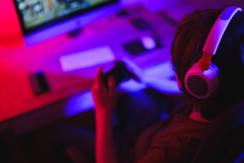 Teenage Boy Playing Multiplayer Games on Desktop Pc in his Dark Room