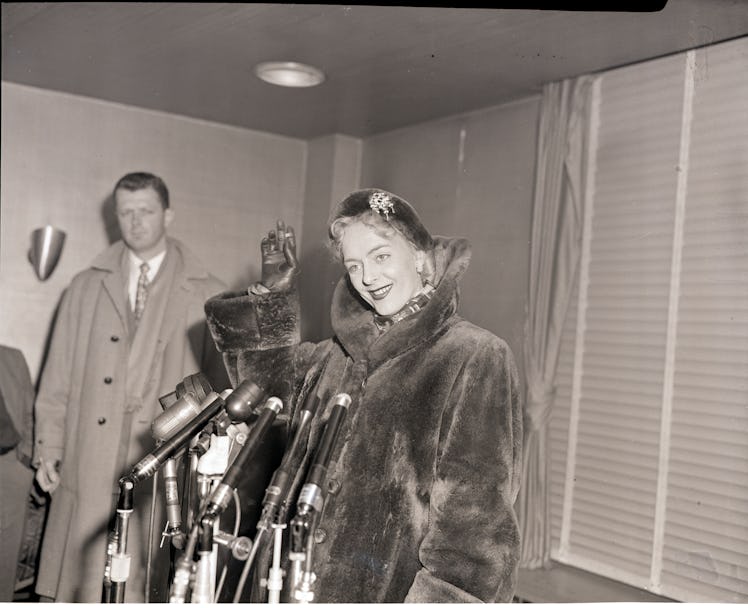 (Original Caption) 2/12/1953-New York, New York- Christine Jorgensen arriving at Idlewild Airport wi...