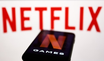 Netflix Games logo displayed on a phone screen and Netflix logo displayed on a screen are seen in th...