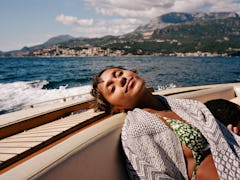 Young woman resting on a speedboat as she considers the zodiac signs that sleep the most