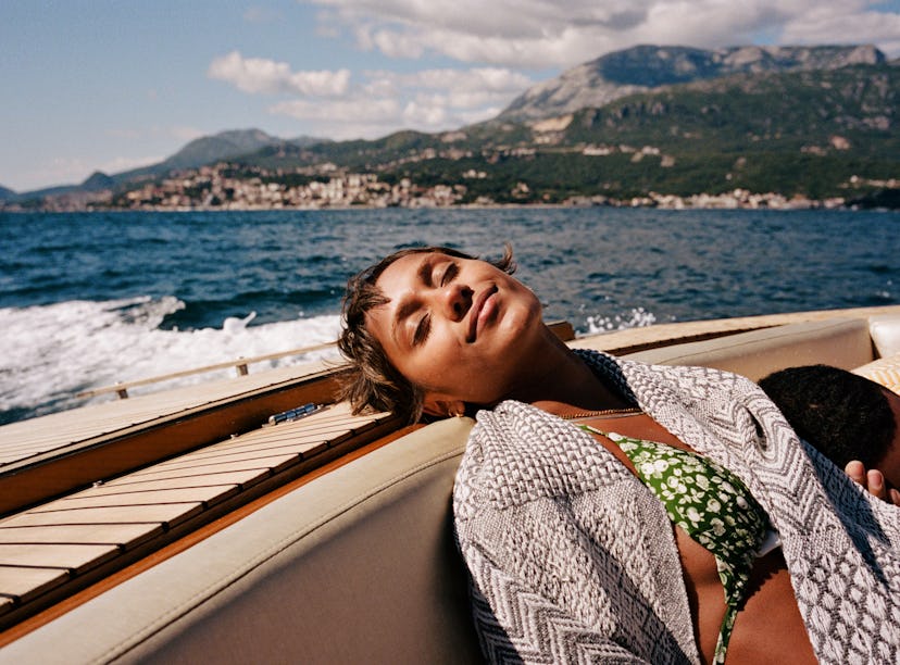 Young woman resting on a speedboat as she considers the zodiac signs that sleep the most