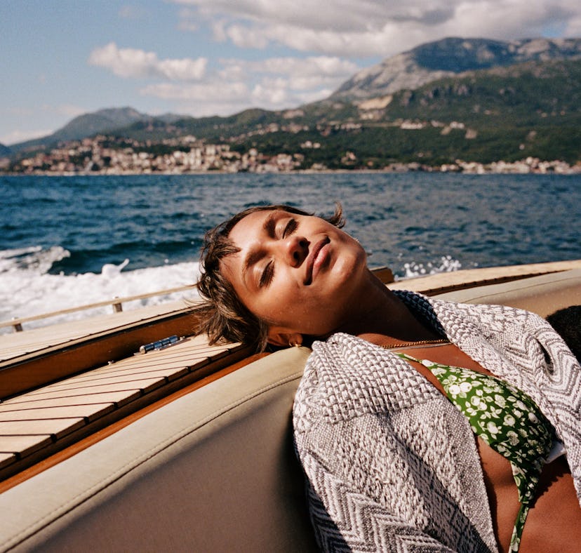 Young woman resting on a speedboat as she considers the zodiac signs that sleep the most
