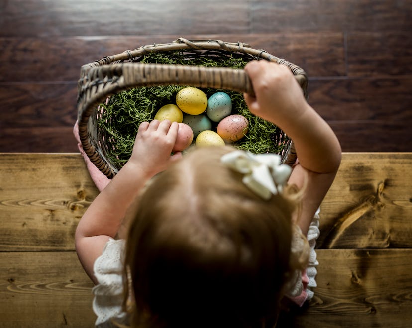 a little girl on an indoor easter egg hunt in the rain
