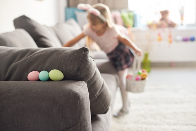 a little girl doing an indoor easter egg hunt