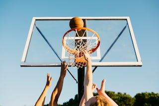 Hands of basketball players trying to take the ball during a game. An Alabama girls basketball team ...