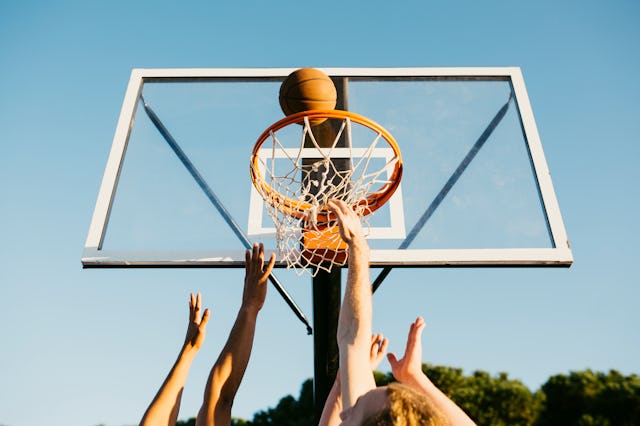 Hands of basketball players trying to take the ball during a game. An Alabama girls basketball team ...