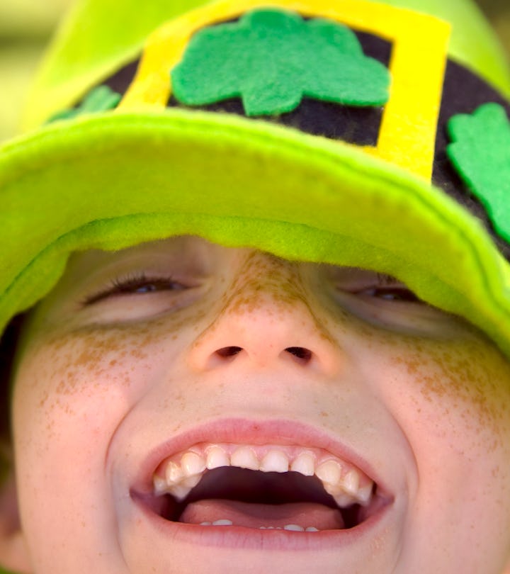 happy kid in green leprechaun hat in st patrick's day puns article