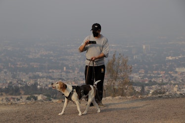 A person and his pet at the top of Cerro de la Estrella, Mexico City, Mexico, on April 25, 2021 and ...