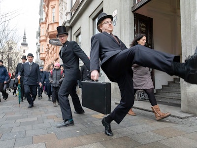 Men take part in a "Silly Walk" event to perform the cult comedy Monty Python's special way to walk,...