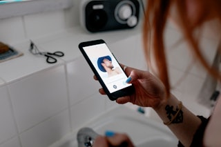 A woman using a dating app on her smartphone to message a man and make plans to meet up.