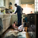 Father cooking breakfast for daughters in kitchen
