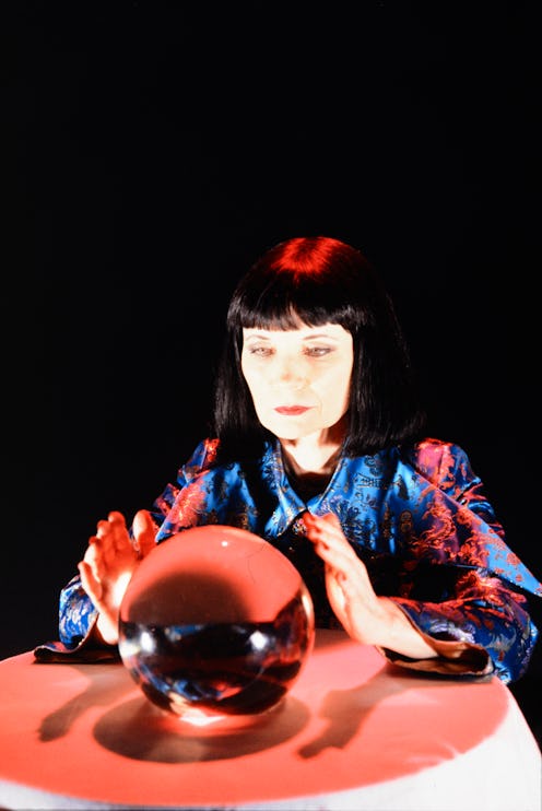 ENGLAND : Mystic Meg all in red, wearing a shaggy nose and gazing into the red, furry ball she is ho...