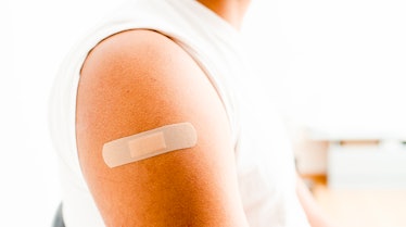 adhesive bandage, on the arm of a black man after giving him the covid19 vaccine.