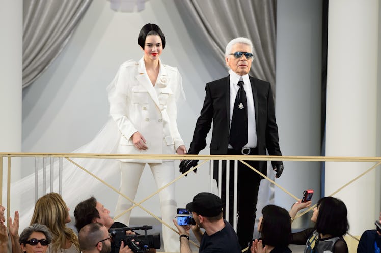 Model Kendall Jenner and Fashion Designer Karl Lagerfeld pose at the end of the Chanel show