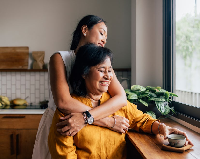 a mother and daughter laughing together about Mother's Day Riddles