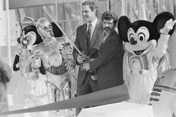 Michael Eisner, chairman of Disney, and film director George Lucas take part in a ribbon cutting cer...