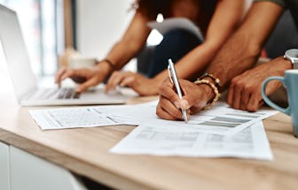 Cropped shot of a couple going over their finances together at home