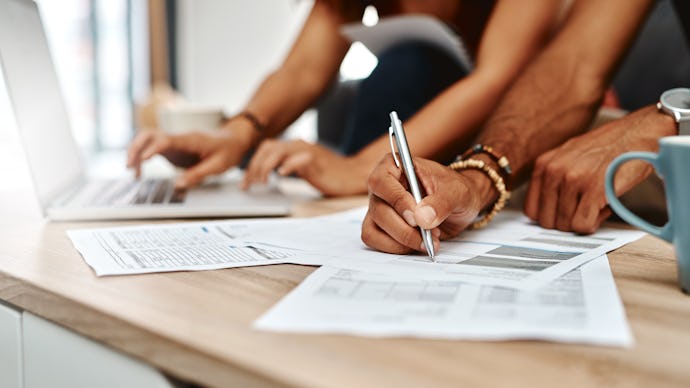 Cropped shot of a couple going over their finances together at home
