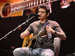 John Mayer performs onstage during his solo acoustic tour.
