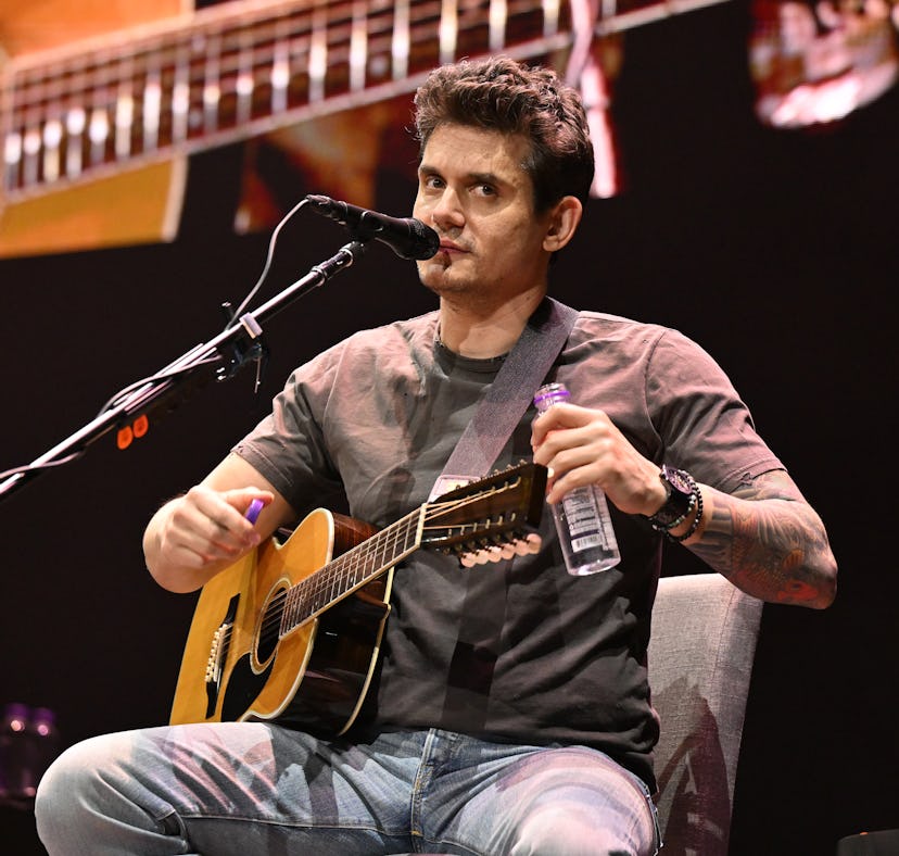 John Mayer performs onstage during his solo acoustic tour.