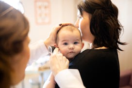 To diagnose baby's ear infection, a pediatrician check's the infant's ears.