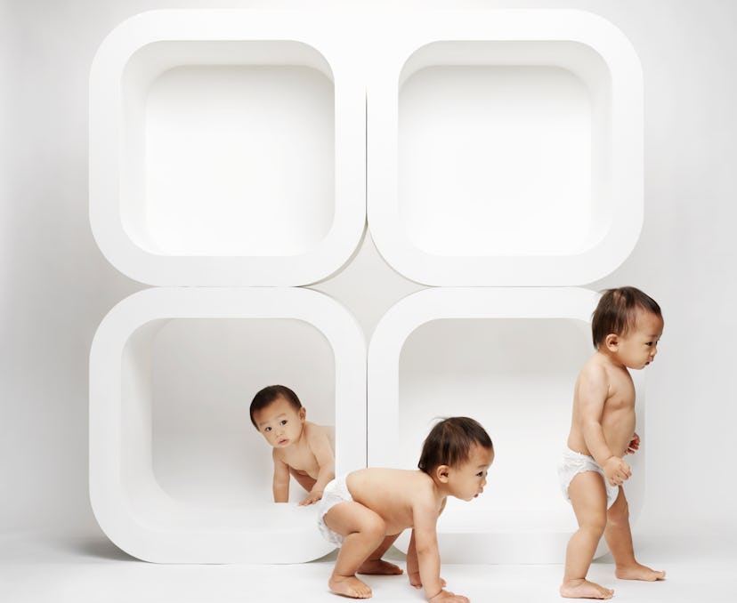 baby triplets on white backdrop in triplet baby boy names roundup