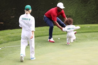 AUGUSTA, GEORGIA - APRIL 05: Harold Varner III of the United States hugs his son, Liam, and wife Ama...