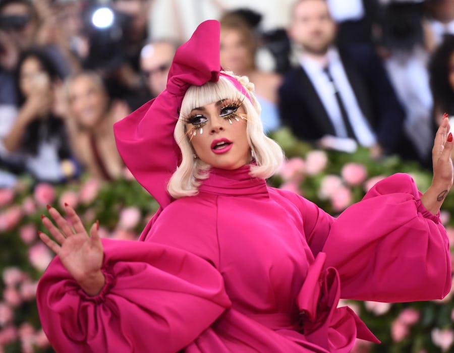 Lady Gaga at the 2019 met gala "camp" in a pink gown and matching headdress