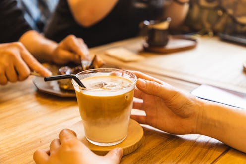 enjoying iced latte with friends in a cafe