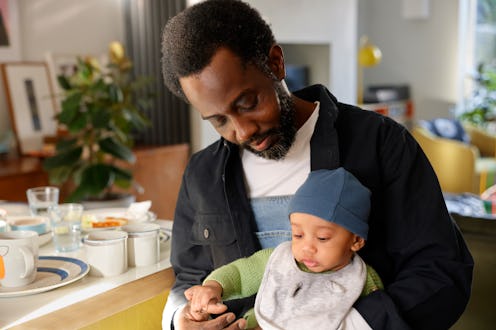 A father spending time with his young baby son at home