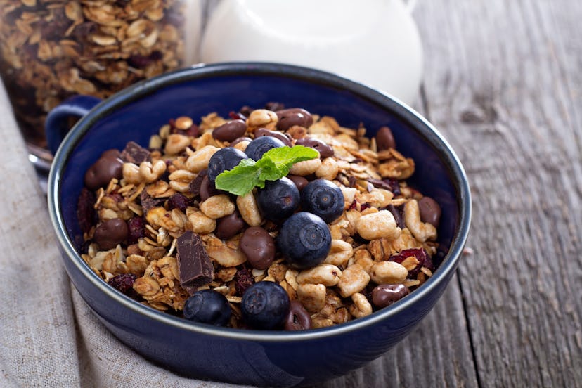 Chocolate breakfast granola with milk and blueberries